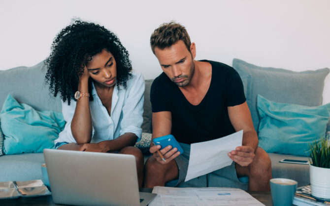a young couple discussing refinancing student loan debt so, it doesn’t ruin their retirement