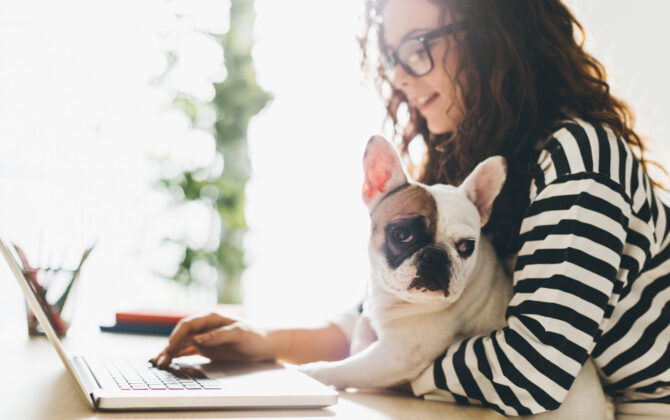 a young girl with her dog researching about student loan consolidation vs. refinancing
