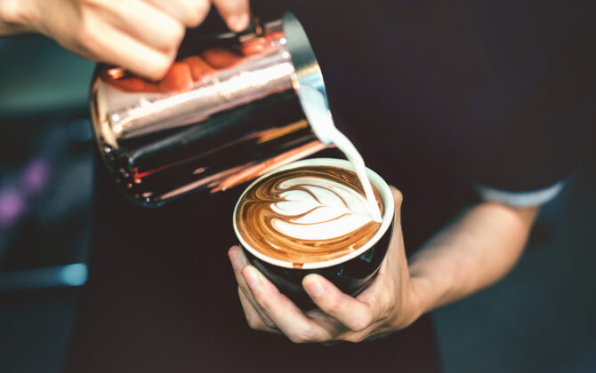 How to make latte art by barista focus in milk and coffee in vintage color tone.