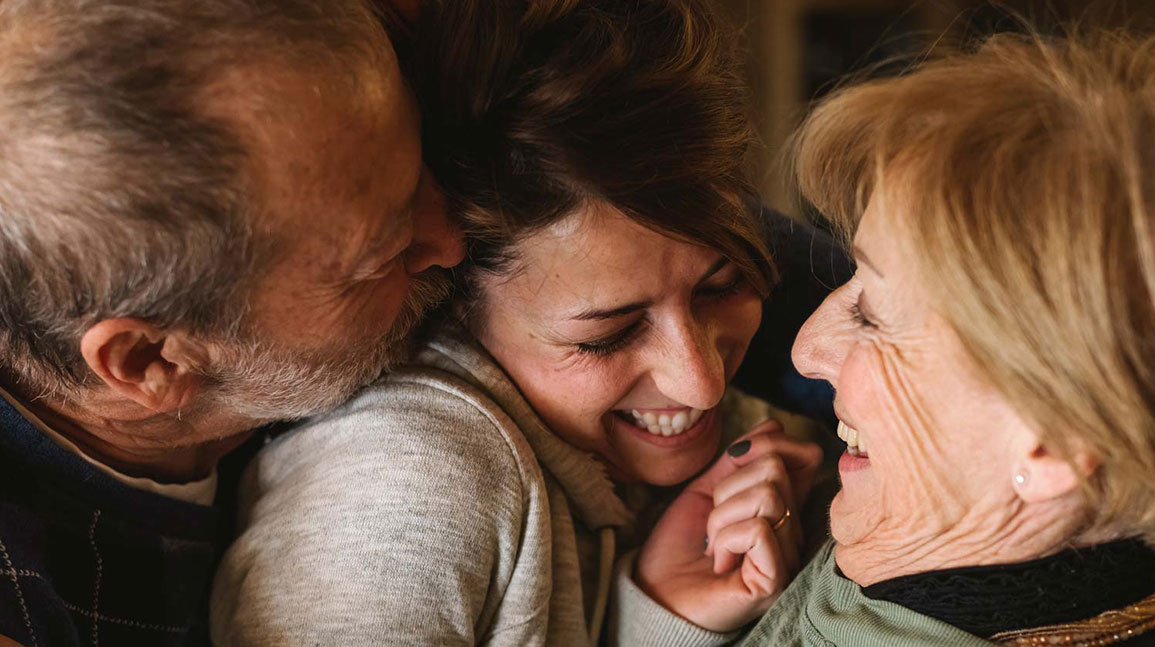 An elderly couple with their daughter.
