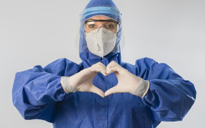 Doctor making heart shape and sending love during coronavirus COVID 19 novel corona virus outbreak