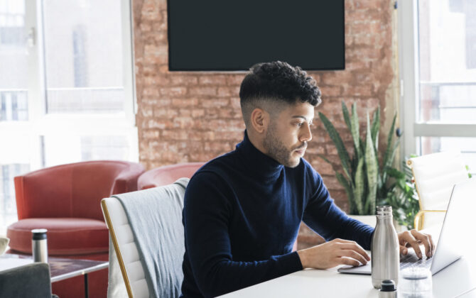 Young man working on laptop.