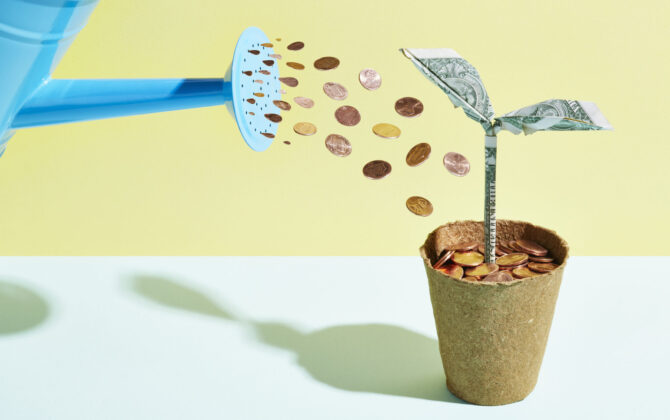 Plant being watered with coins