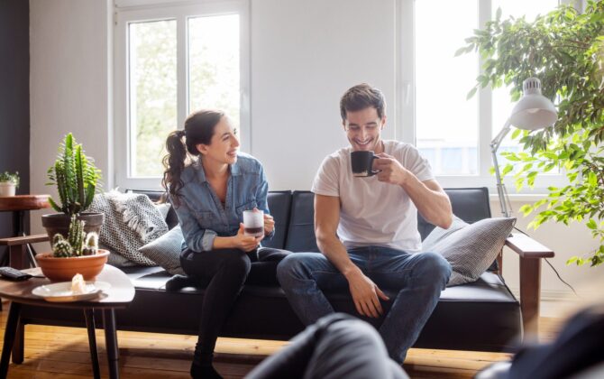 Couple-having-coffee-on-couch