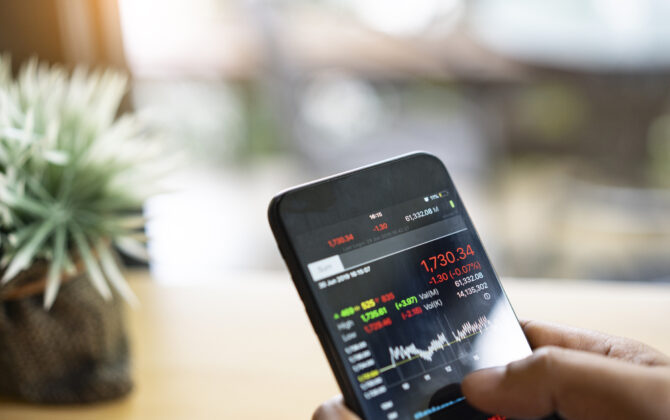 businessman using a mobile phone to check stock market data