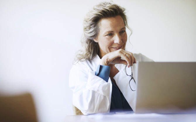 A female doctor reading about the fundamentals of investing.