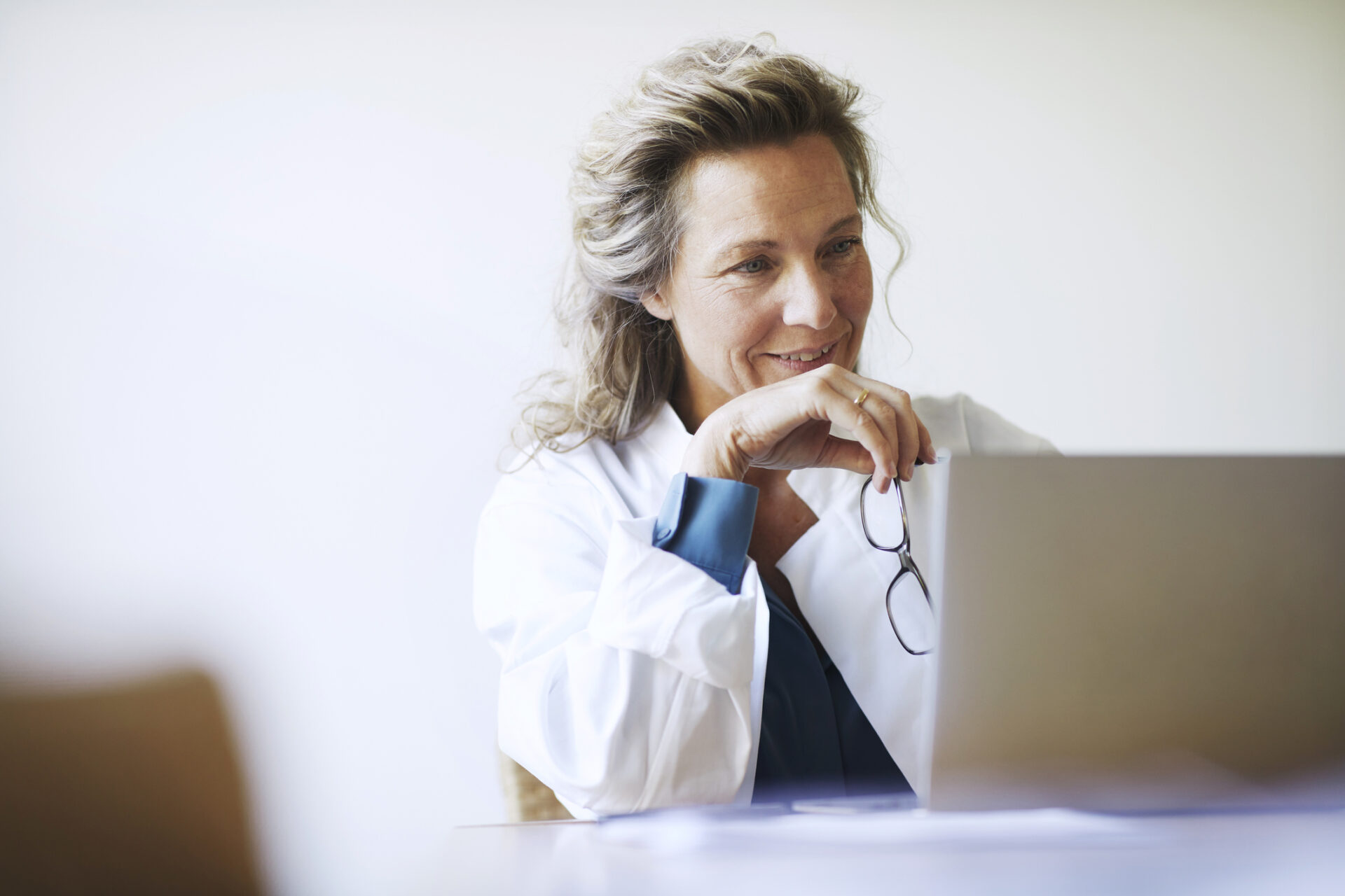 A female doctor reading about the fundamentals of investing.