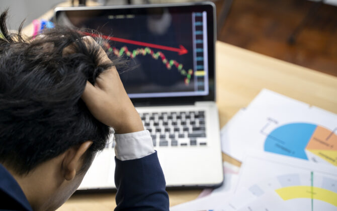Stock trader tearing out his hair from despair.
