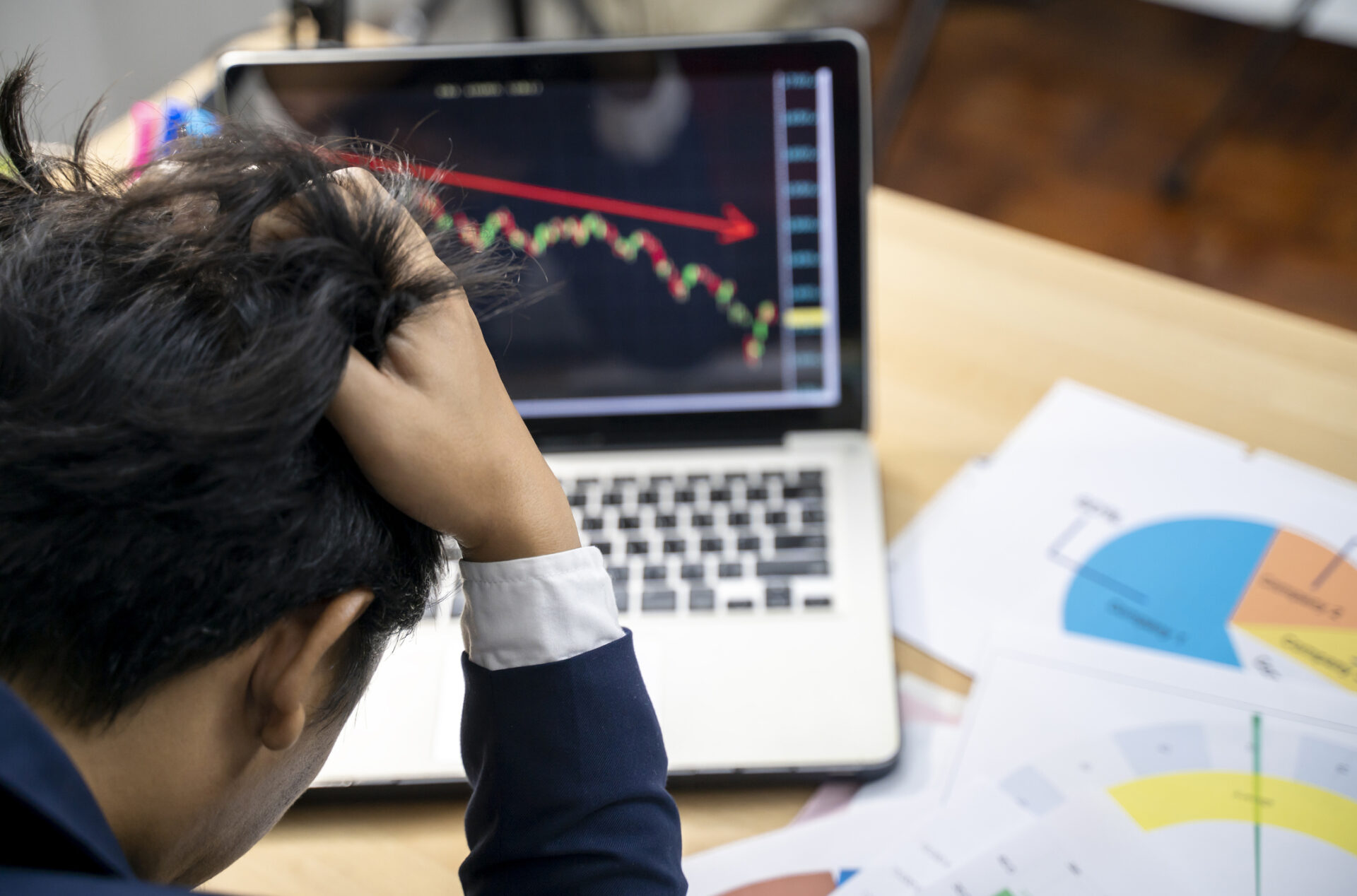 Stock trader tearing out his hair from despair.