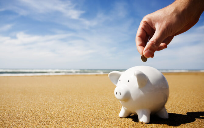 Piggy bank being filled at the seaside
