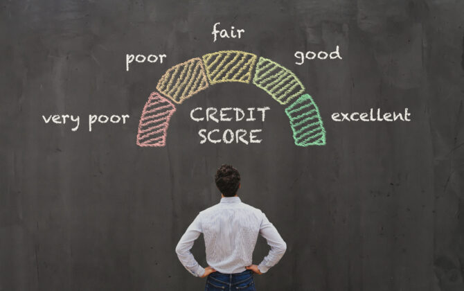 Man looking at chalkboard depicting credit scores ranging from poor to excellent.