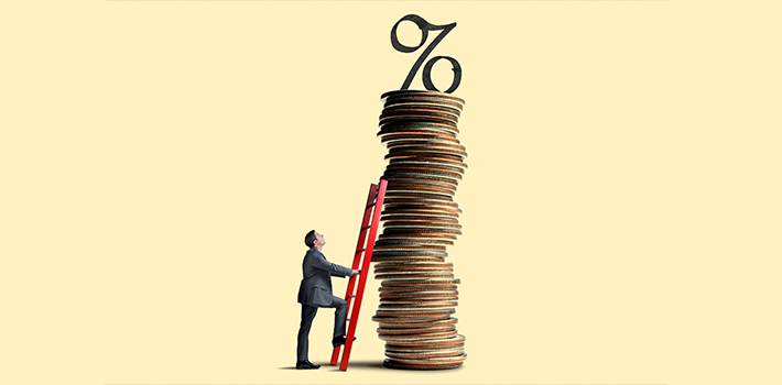 Man climbing ladder propped against a pile of coins with a percentage point at its top, metaphorically depicting rising interest rates.