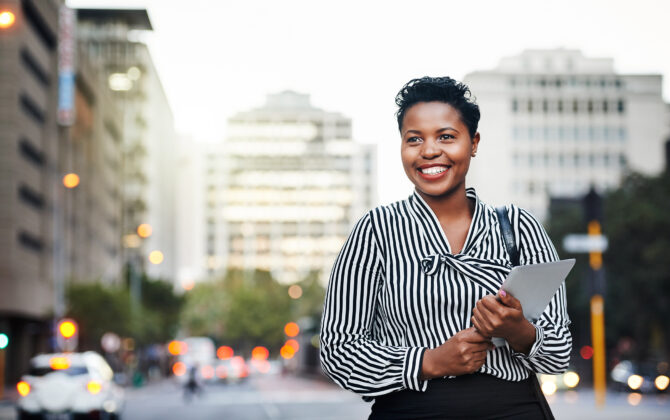 Shot of a young businesswoman holding a digital tablet in the city