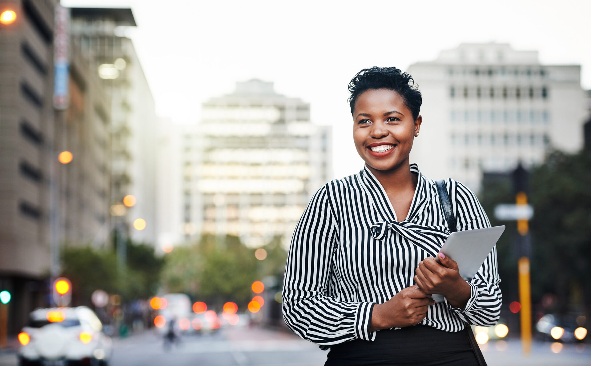 Shot of a young businesswoman holding a digital tablet in the city