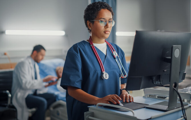 Hospital Ward: Professional Smiling Black Female\Doctor Wearing Stethoscope Using Computer.