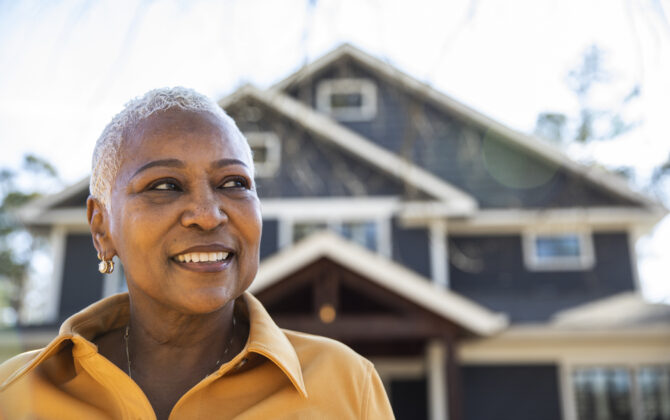 Portrait of senior woman in front of her house