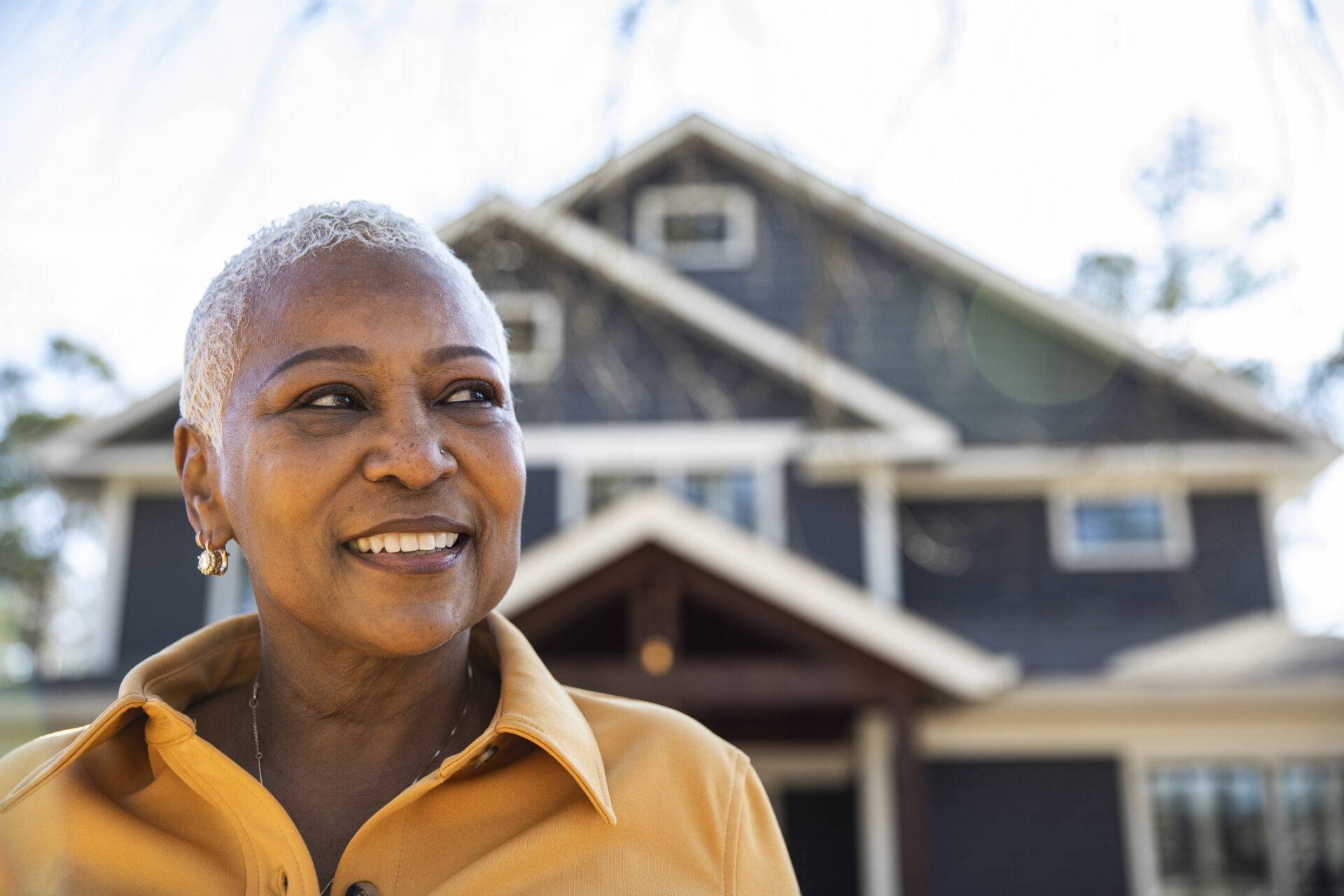 Portrait of senior woman in front of her house