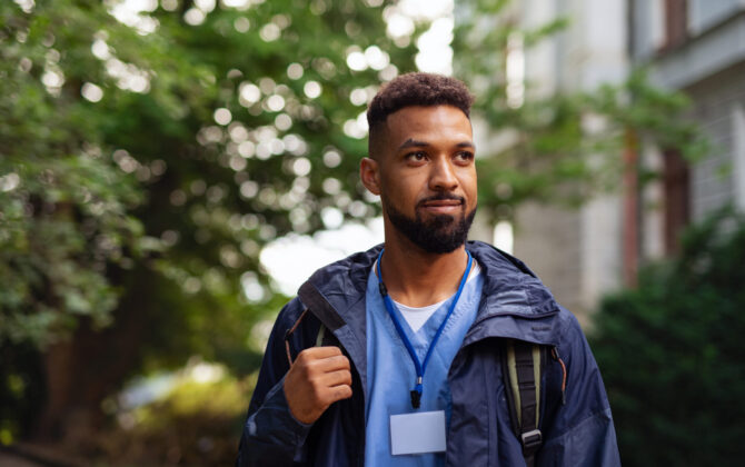 Male healthcare worker outdoors on the way to work.