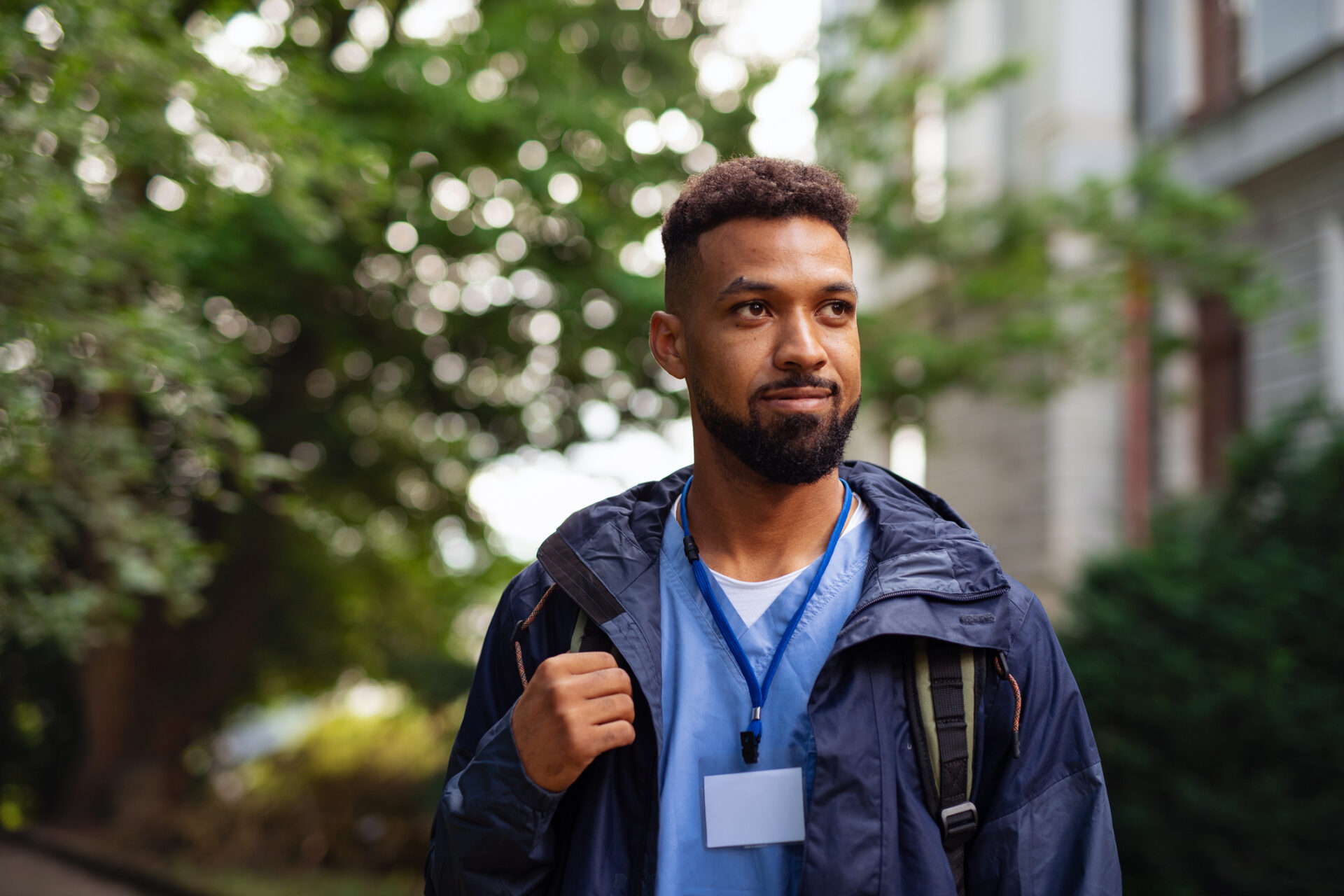 Male healthcare worker outdoors on the way to work.