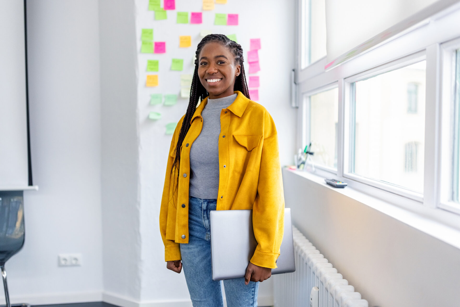 Portrait of a smiling young woman working at startup company