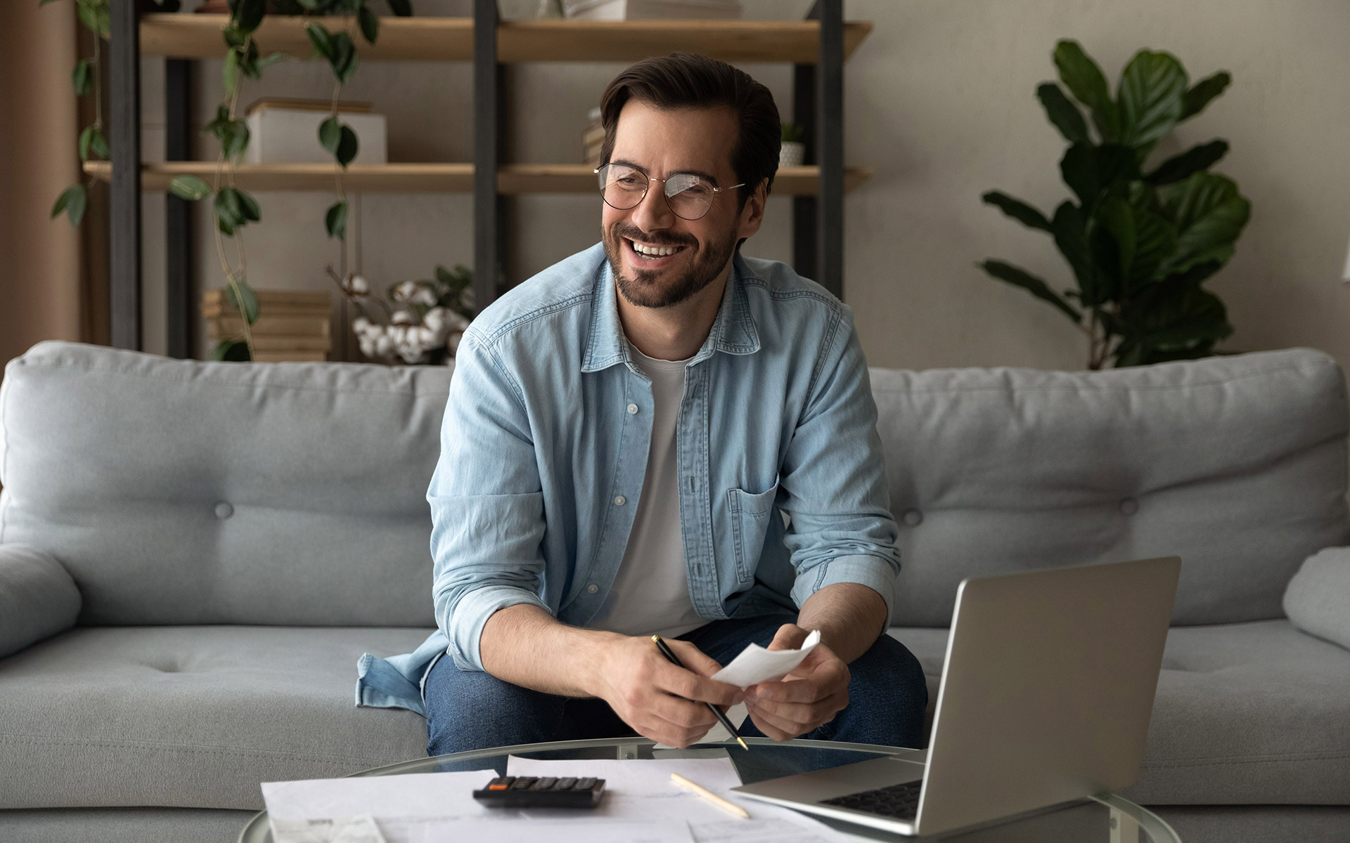 A happy man after knowing the impact of paying off his student loans