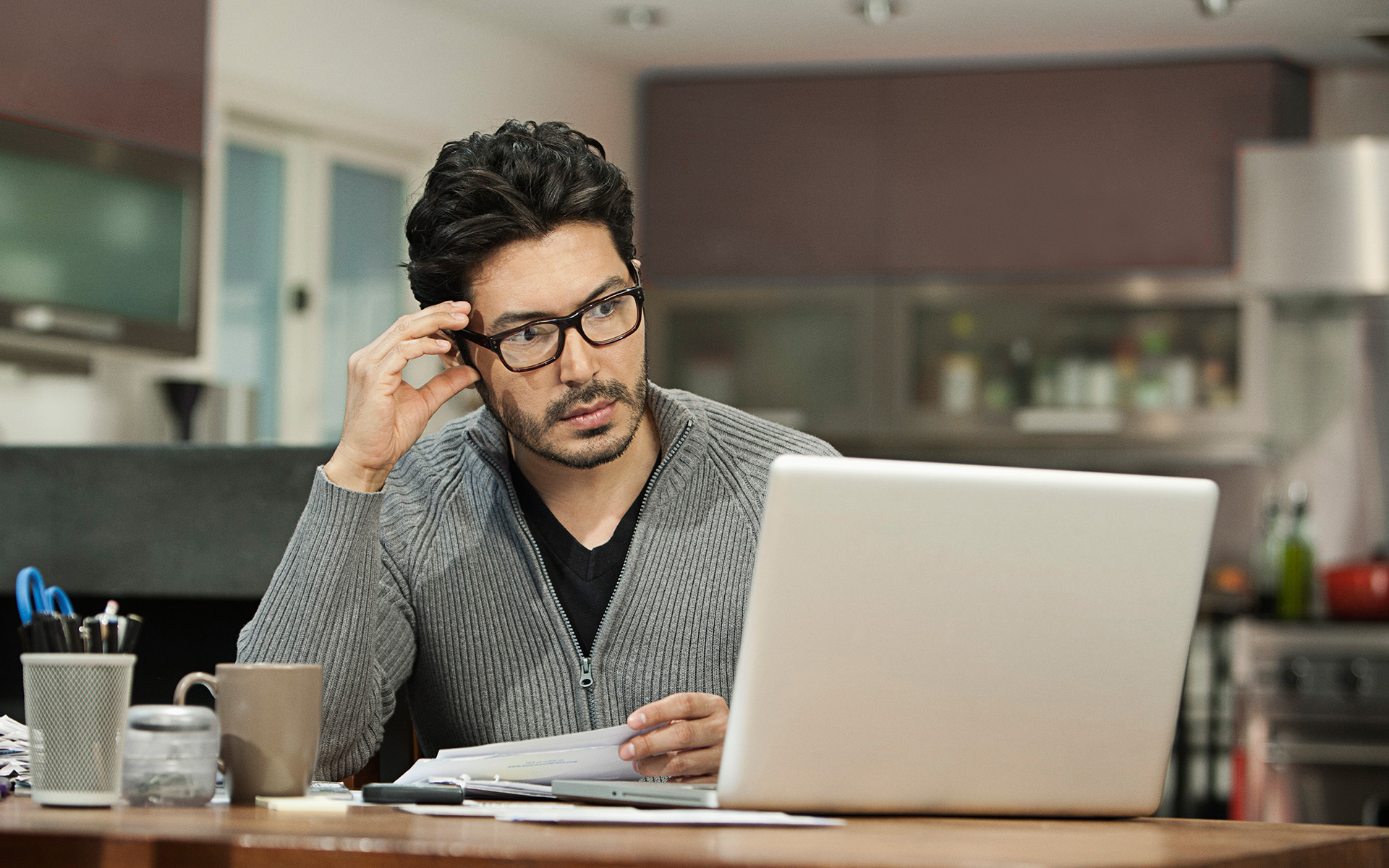 Professional man reads about the penalties of missing student loan payments